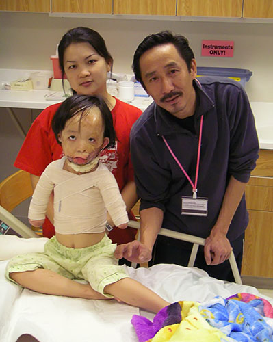 Boun Lod, feeling better, with her mom and dad.